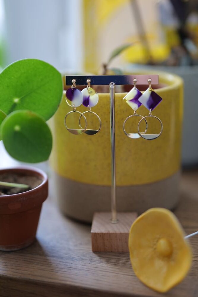 Deux paires de boucles d'oreilles (fermoirs puces plaqué or 14k) avec ronds et carrés de résine colorée (violet, jaune, blanc) et pampilles rondes plaqué or 14k